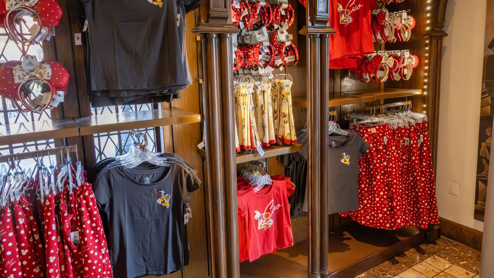 A section of Il Bel Cristallo in World Showcase at Epcot displaying Minnie Mouse ear headbands, shirts and skirts