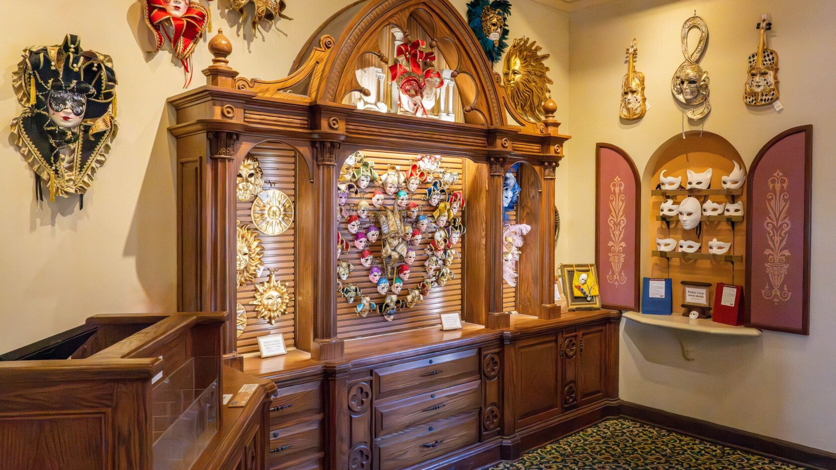 A section of Il Bel Cristallo at Epcot with carved wooden cabinets displaying Venetian carnival masks