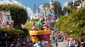 Tinker Bell greets Guests from atop her nature-themed float