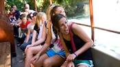 Passengers react with delight to the sites on a Jungle Cruise adventure