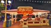 The sign for Angry Dogs features a person clenching his teeth with a flaming hotdog overhead