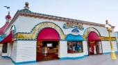 Neon lights wrap around the exterior of Knicks Knacks, a souvenir store