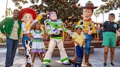 A family poses with Woody, Buzz Lightyear and Jessie at Pixar Pier
