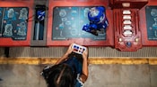A child builds a customized droid at Droid Depot