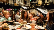 A family eating at a dinner table in Morimoto Asia
