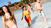 Teens walk in the shallow water at the Typhoon Lagoon Surf Pool