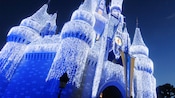 Cinderella Castle decorated in holiday lights