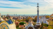 The spire of a church steeple with ceramic inlays overlooking a dense metropolis The spire of a church steeple with ceramic inlays overlooking a dense metropolis