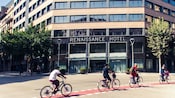 Bike riders cycling outside the entrance of the Renaissance Barcelona Hotel