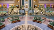 The lobby of the multi story Hyatt Regency Orlando reveals fountains, plants and escalators