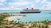 Un crucero de Disney atracado junto a una playa tropical