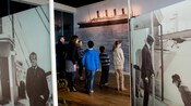 Guests viewing oversized images of the Titanic in a museum exhibit