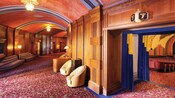 A vintage theater and lobby with wood paneling and art deco decor