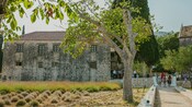 Guests standing outside a stone monastery