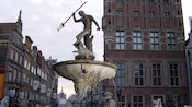 A fountain with a statue of Poseidon at its center