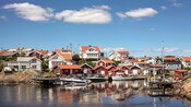 Small boats lining a seaside community filled with wooden cottages