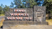 A sign on a rock wall that reads, ʻHawaii Volcanoes National Parkʻ