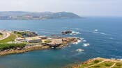 A coastline featuring a building complex on a small cape