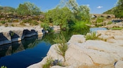The ruins of an ancient aqueduct near a tranquil body of water