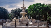 A park featuring a marble fountain with statues