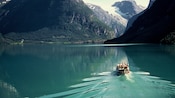 A boat carrying Guests rides across Lake Loen