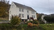 A 2 story Georgian home with gardens and a burning fire pit