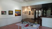 A table with art supplies in a contemporary room with artwork hanging on the walls