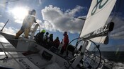 A Guest at the helm of a racing yacht