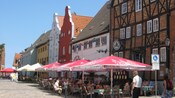 A historical European town with sidewalk cafes
