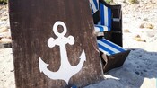 A ship anchor painted on a wooden board