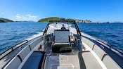 A captain sailing a speedboat near a cluster of verdant isles