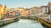 A bridge over a river that flows through a city