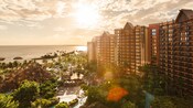 A sweeping view of Aulani, A Disney Resort and Spa in Ko Olina, Hawaii and the ocean, as the sun begins to set