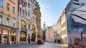 Una calle de adoquines con edificios coloridos y una mezcla de estilos arquitectónicos en Riga, Letonia