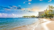 Ocean waves lapping on the serene shore adjacent to the Caribe Hilton hotel in San Juan, Puerto Rico