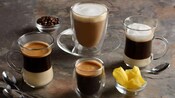 An assortment of 4 coffee drinks in various size glasses