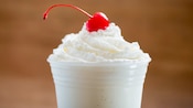 A vanilla shake with whipped cream and a cherry