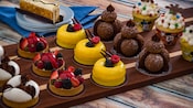 A selection of artfully designed desserts and pastries on a tray