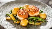 Seared scallops served with vegetables
