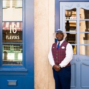 A VIP guide stands proudly outside an ice cream parlor