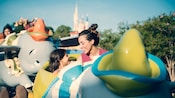 A mother and her daughter riding the Dumbo the Flying Elephant attraction at Magic Kingdom park A mother and her daughter riding the Dumbo the Flying Elephant attraction at Magic Kingdom park