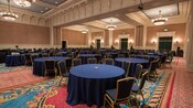 Round tables surrounded by chairs in a large ballroom