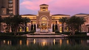 The entrance to the Four Seasons Orlando Resort has a pond and neoclassical architecture