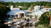 4 boats docked in the waters near the gabled exterior of Disney's Old Key West Resort
