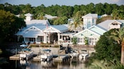 4 boats docked in the waters near the gabled exterior of Disney's Old Key West Resort