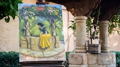 A well and a painting of Snow White sitting on a well