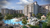 An enormous Resort swimming pool with a water slide that winds down from a tower