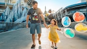 A little girl and her dad holding hands while walking through Tomorrowland at Magic Kingdom park A little girl and her dad holding hands while walking through Tomorrowland at Magic Kingdom park