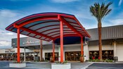 A large, rounded awning stretches out from above the lobby doors of the Anaheim Hotel