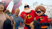 A family of four meets Mr Incredible and Elastigirl at Pixar Pier A family of four meets Mr Incredible and Elastigirl at Pixar Pier